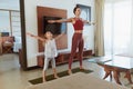 Family Workout At Home. Mother And Daughter Exercising In Living Room. Little Girl And Young Woman Practicing On Mat. Royalty Free Stock Photo