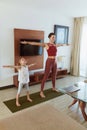 Family Workout At Home. Parent And Child Exercising In Living Room. Little Girl And Young Woman Practicing On Mat. Royalty Free Stock Photo