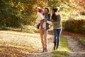 Family With Young Daughter Enjoying Autumn Countryside Walk Royalty Free Stock Photo