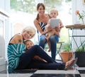 This familys love knows no boundries. Portrait of a happy lesbian couple relaxing with their children in a kitchen.