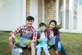 Famiy and kid sitting on a grass in their house garden after gardening Royalty Free Stock Photo