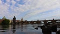 the famos Charles Bridge that crosses the Vltava river in Prague, Czech Republic. againt a cloudy bright sky