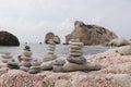 Famous Afroditi beach in Cyprus. Constructions of stones Opposite Aphrodite hill. Forbidden bathing. Childhood. Wonderful pyramid Royalty Free Stock Photo