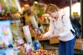 The famous Amsterdam flower market Bloemenmarkt. Mature women choose tulip bulbs