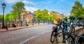 Famous Amsterdam in one photo - leaning houses, bridges, canals, bicycles and lanterns. Panorama of the famous old center of Royalty Free Stock Photo