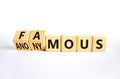 Famous or anonymous symbol. Concept word Famous and Anonymous on wooden cubes. Beautiful white table white background. Business