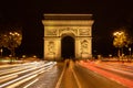 Famous Arc de Triomphe monument in Paris with traffic lights trails at night, France Royalty Free Stock Photo