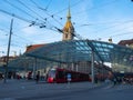Berne, Switzerland - April 15th 2022: Tram stop main station with its glass roofing in front of historic buildings