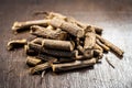 Famous ayurvedic herb Licorice root or Liquorice root or Mulethi on wooden surface.