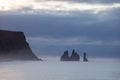 Famous basalt sea stacks of Reynisdrangar, rock formations on the black sand of Reynisfjar beach, view not far from Vik, a small v Royalty Free Stock Photo