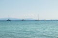 Sailing Boats and Wind Surfing inside the green Greek Ocean. Royalty Free Stock Photo