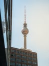 Famous Berlin Television Tower, observation Tower with office building in front, view from low angle during sunset, clear sky Royalty Free Stock Photo