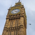 The famous Big Ben clock tower with a helicopter in the background in London in England, United Kingdom Royalty Free Stock Photo