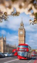 Famous Big Ben with red double decker bus on bridge over Thames river during springtime in London, England, UK Royalty Free Stock Photo