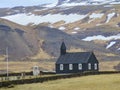 Famous black church of Budir at Snaefellsnes peninsula region in Iceland. Amazing rocks and mountain view on background Royalty Free Stock Photo