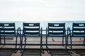 Famous blue chairs on the Promenade des Anglais of Nice, France against the backdrop of the blue sea. Royalty Free Stock Photo