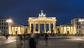 Famous Brandenburg Gate in the evening with tourists around