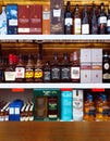 Famous brands whiskey assortment on the wine store wooden shelves