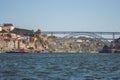 Famous bridge Ponte Luis in Porto bottom view. Riverside near giant steel bridge with people and boats. Royalty Free Stock Photo