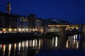 Famous bridge Ponte Vecchio with reflection in river Arno at night in Florence, Italy Royalty Free Stock Photo