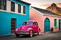 Famous bright color retro car parked by colorful houses in Bo Kaap district in Cape Town.