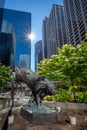 Famous bull statue surrounded by modern buildings in Calgary
