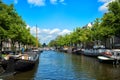 Canals and embankments with boats of Amsterdam city. Royalty Free Stock Photo