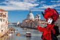 Famous Carnival mask on bridge against Grand Canal in Venice, Italy Royalty Free Stock Photo