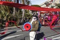 Famous Carnival of Nice, Flowers` battle. Male Entertainer in carnival Costume launches colored ribbons