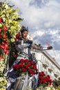 Famous Carnival of Nice, Flowers` battle. A woman entertainer with red flowers