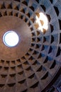 The famous cassette ceiling dome of Pantheon temple of all the gods with wide open rotunda on the top. Sunlight rays penetrating Royalty Free Stock Photo