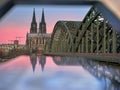 The famous cathedral in the German city of Cologne and the Hohenzollern Bridge over the river Rhine in a natural frame. Royalty Free Stock Photo