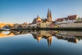 Famous city view of Regensburg and promenade with stone bridge the river Danube the historical old town and the cathedral St. Pete Royalty Free Stock Photo