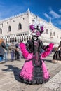 Colorful carnival masks at a traditional festival against Doge palace in Venice, Italy Royalty Free Stock Photo