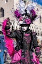 Colorful carnival masks at a traditional festival against Doge palace in Venice, Italy Royalty Free Stock Photo