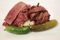 Famous Corned Beef and Pastrami on rye sandwich served with pickles Royalty Free Stock Photo