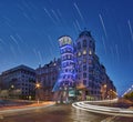 The dancing house in Prague in harmony with curved light trails and stars