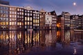 Famous dancing houses of the Damrak canal in Amsterdam at night