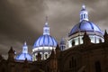 Famous domes of the New Cathedral in Cuenca, Ecuador rise over the city skyline at dusk Royalty Free Stock Photo