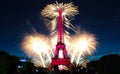 Famous Eiffel Tower and beautiful fireworks during celebrations of French national holiday - Bastille Day. Royalty Free Stock Photo