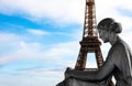 The Eiffel Tower in Paris in the arms of a statue of a seated woman