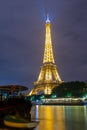 Famous Eiffel tower and Seine river with colorful reflections at night, Paris, France Royalty Free Stock Photo