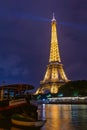 Famous Eiffel tower and Seine river with colorful reflections at night, Paris, France Royalty Free Stock Photo