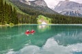 Emerald Lake, Yoho National Park, British Columbia, Canada. Turquoise water and green trees. Red canoe on the lake Royalty Free Stock Photo