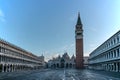 Famous empty San Marco square with Basilica of Saint Mark and Bell Tower at sunrise,Venice,Italy.Early morning at popular tourist Royalty Free Stock Photo