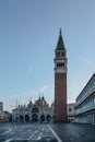 Famous empty San Marco square with Basilica of Saint Mark and Bell Tower at sunrise,Venice,Italy.Early morning at popular tourist Royalty Free Stock Photo