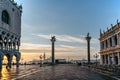 Famous empty San Marco square with Doges Palace at sunrise,Venice,Italy.Early morning in popular tourist destination.World famous Royalty Free Stock Photo