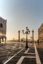 Famous empty San Marco square with Doges Palace at sunrise,Venice,Italy.Early morning in popular tourist destination.World famous Royalty Free Stock Photo