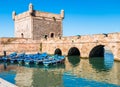 Famous Essaouira fort in Morocco with blue fishing boats Royalty Free Stock Photo