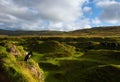 Highland mountain with a lonely people and dog on top , Skye,Scotland